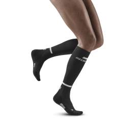 Brooks running shoes and CEP compression socks, legs female runner